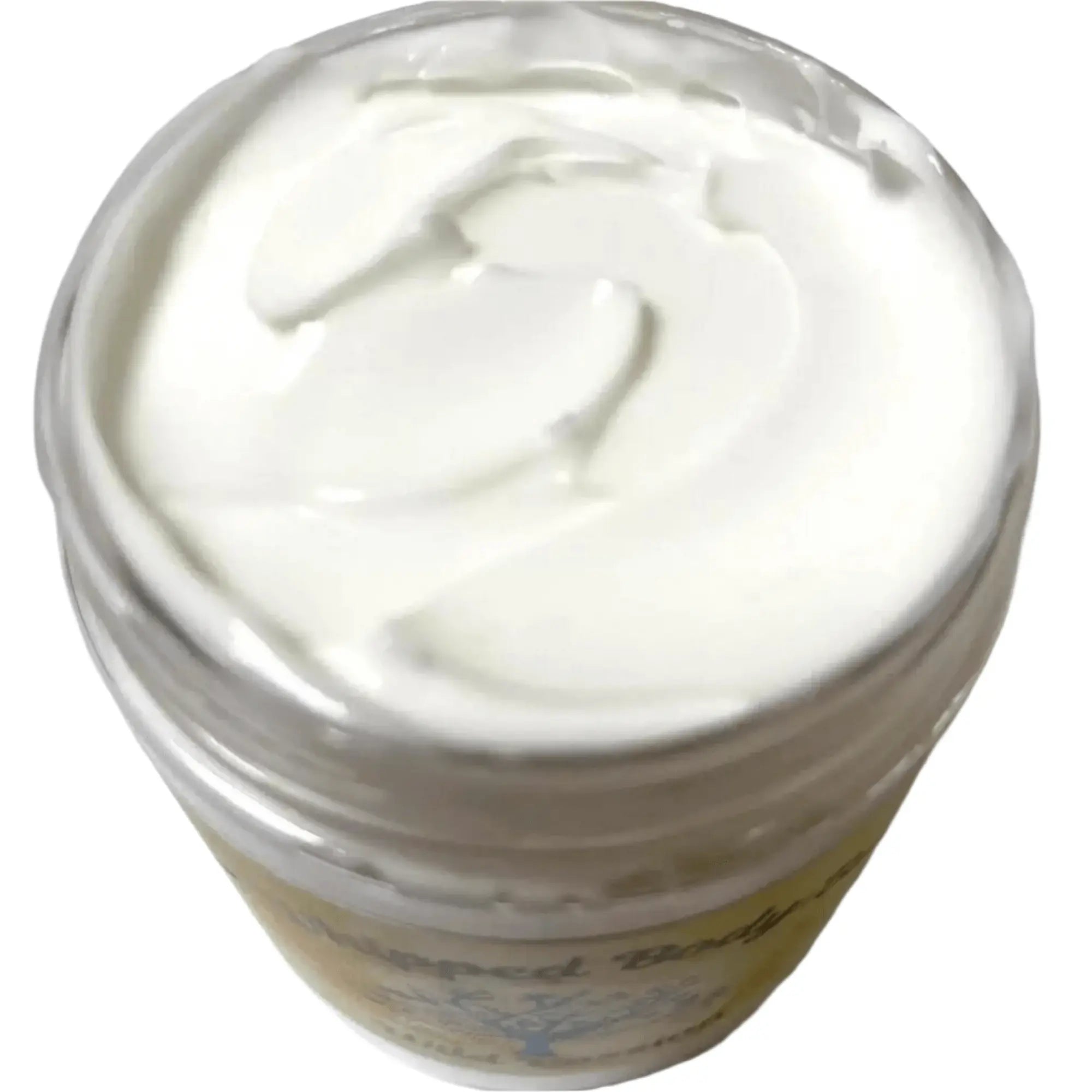 Top view of creamy, whipped body butter in a jar, showcasing its rich texture and luxurious formula.